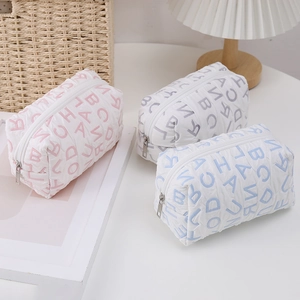 Quilted fabric cosmetic bags with alphabet print in pink, grey and blue colors