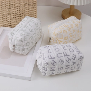 Detail of quilted canvas storage bag showing soft texture and letter pattern texture