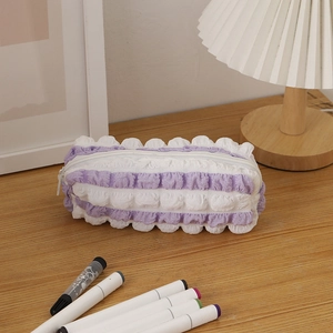 Detail of purple 3D bubble texture stationery bag with ruffle trim on a wooden table