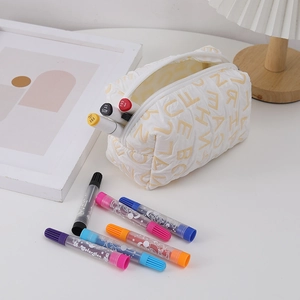 Macro view of white quilted canvas stationery bag with light yellow alphabet patterns
