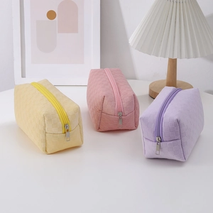 Three-piece checkered waffle fabric pencil cases in yellow, pink and purple with zippers