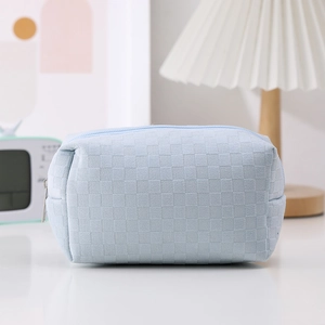 Detail of light blue checkerboard pencil case with soft texture and sturdy zipper closure