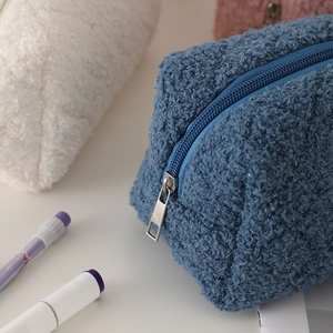 Macro detail of soft fuzzy sherpa fabric texture on large capacity plush pencil case