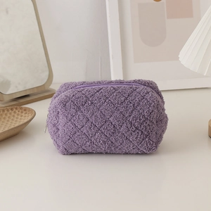 Close-up of a purple quilted plush pencil case with a soft lamb wool texture and zipper