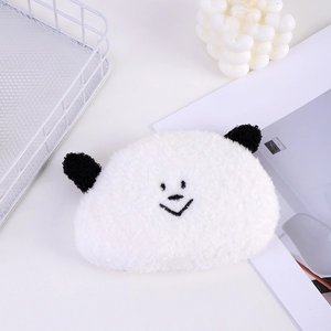 Detail of panda plush coin purse with lamb wool texture and embroidered face on white background
