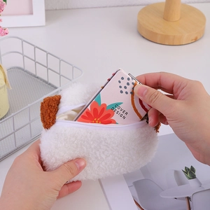 Detail view of the white plush puppy coin purse zipper opening with floral card insert