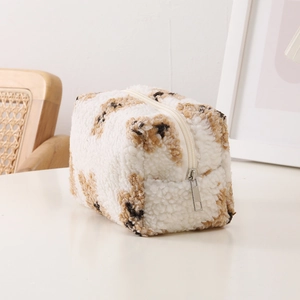 Close-up of plush leopard print storage bag with soft texture and beige zipper detail