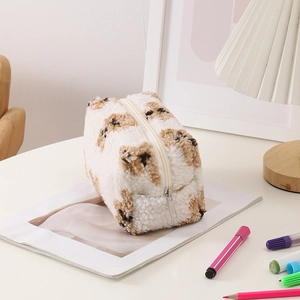 Detail of cute bear pattern on soft teddy fleece makeup bag with smooth zipper closure