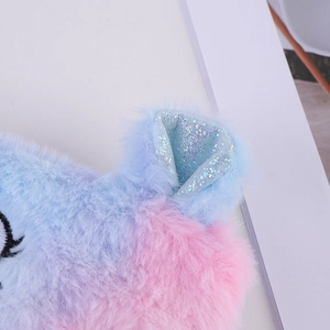 Close-up of pink and blue gradient plush texture with sparkly sequin cat ear detail