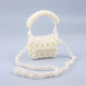 Elegant beaded pearl handbag with top handle and crossbody strap in creamy white