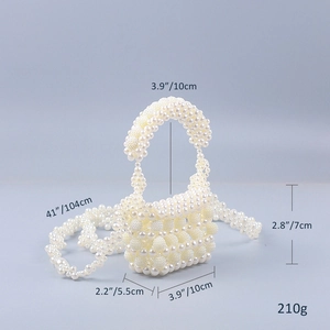 Detailed view of handmade pearl mini handbag showing size and strap length specs