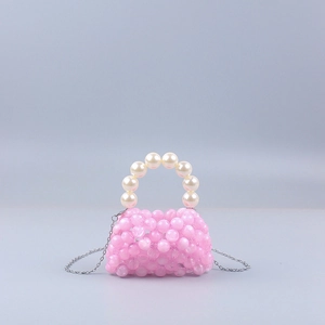 Detailed view of pink beaded mini bag with pearl handle and silver chain strap