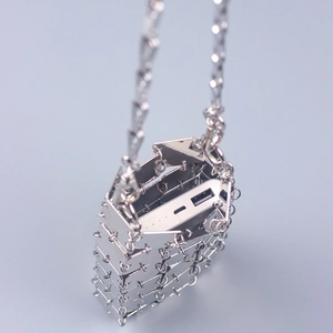 Detail view showing polished metal plate patchwork and storage capacity for a mini bag