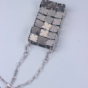 Detailed view of silver metal square chain link bag with punk industrial style design