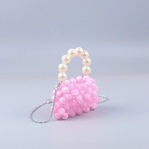 Detail of pink acrylic beaded mini bag with pearl handle and silver chain strap