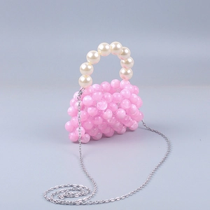 Detail of pink acrylic beaded mini bag with pearl handle and silver metal chain strap