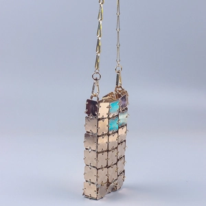 Detailed view of handmade gold metal sequin crossbody phone bag with chain strap