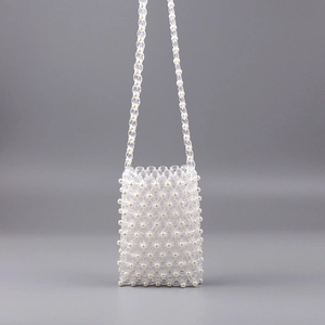 Detail of handmade beaded crossbody phone bag with clear acrylic and white pearls