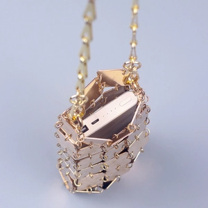 Golden square metal patch bucket bag with chain strap and interior capacity display