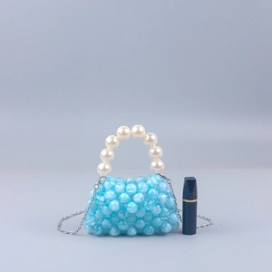 Detail of blue acrylic beaded mini bag with pearl handle and metal chain for scale