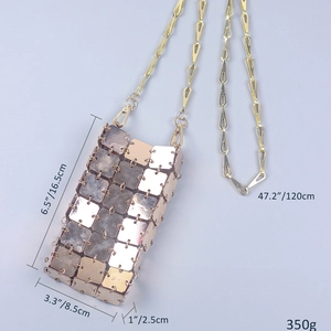 Detail of handmade woven mobile bag with gold metal square sequins and chain strap