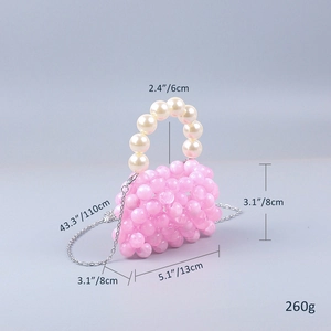 Detailed view of pink acrylic bead handbag with cream pearl handle and silver chain strap
