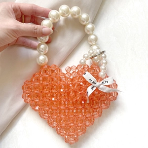 Orange heart-shaped acrylic beaded handbag with large pearl handle and silk bow