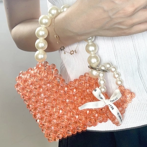 Handmade heart-shaped beaded handbag with orange acrylic beads and pearl handle