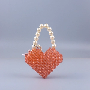 Handmade orange acrylic heart-shaped beaded handbag with elegant pearl handle for parties