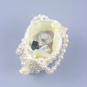 Handmade pearl beaded tote bag with satin drawstring lining showing interior storage space