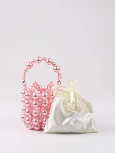 Close-up of pink beaded handbag with a white satin drawstring inner pouch detail