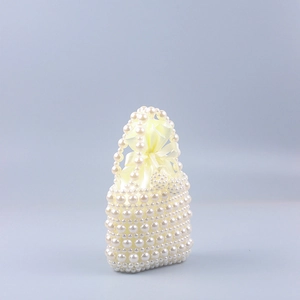 Handmade pearl beaded tote bag with a yellow satin drawstring liner for weddings