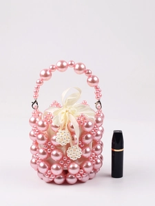 Detail of pink pearl beaded mini bucket bag with satin drawstring liner and lipstick scale