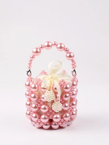 Detailed view of pink pearl beaded handbag with white satin drawstring lining and metal clasp