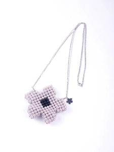 Detail of handmade beaded flower mini bag with pink pearls and silver chain strap