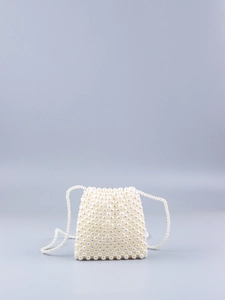 Détail d'un sac bandoulière fait main en perles nacrées avec une bandoulière perlée élégante