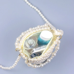 Mini pearl woven handbag with satin lining showing storage for perfume and lipstick