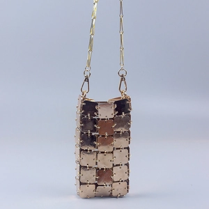 Detailed view of handmade golden square metal sequins and chain on a crossbody phone bag