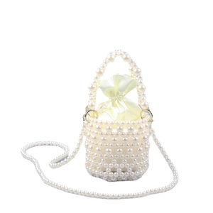Elegant white pearl woven bucket bag with yellow satin drawstring pouch and shoulder strap