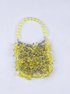 Detail of yellow handmade woven crystal beaded handbag with multi-faceted acrylic drops