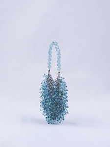 Detail of light blue crystal beaded handbag with teardrop crystals and silver metal clasp