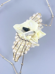 Internal view of mini pearl beaded bag showing capacity for lipstick and power bank