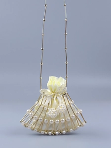 Macro detail of fan-shaped evening bag with gold metal frame, pearls and cream satin lining