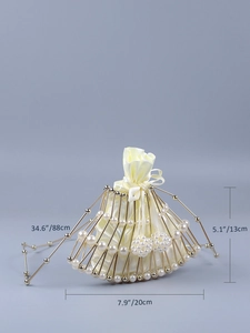 Detail of beaded birdcage evening bag with size dimensions and pearl-embellished frame