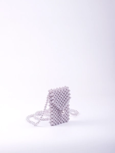 Macro shot of light purple woven pearl mini bag with large central pearl buckle