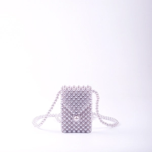 Handmade pearl woven mini crossbody bag with light purple iridescent finish and long strap
