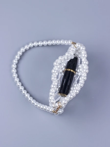 Detail of handmade faux pearl mini handbag showing capacity with lipstick and gold clasp