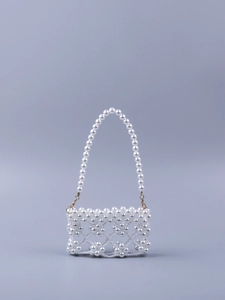 Detailed view of handmade faux pearl weaving on a vintage-style evening clutch bag