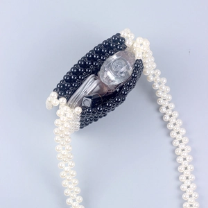 Detailed top view of mini handmade pearl beaded bag interior showing small storage capacity