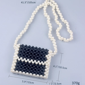 Detailed view of handmade beaded mini bag with dimensions 15cm x 10.5cm and strap specs